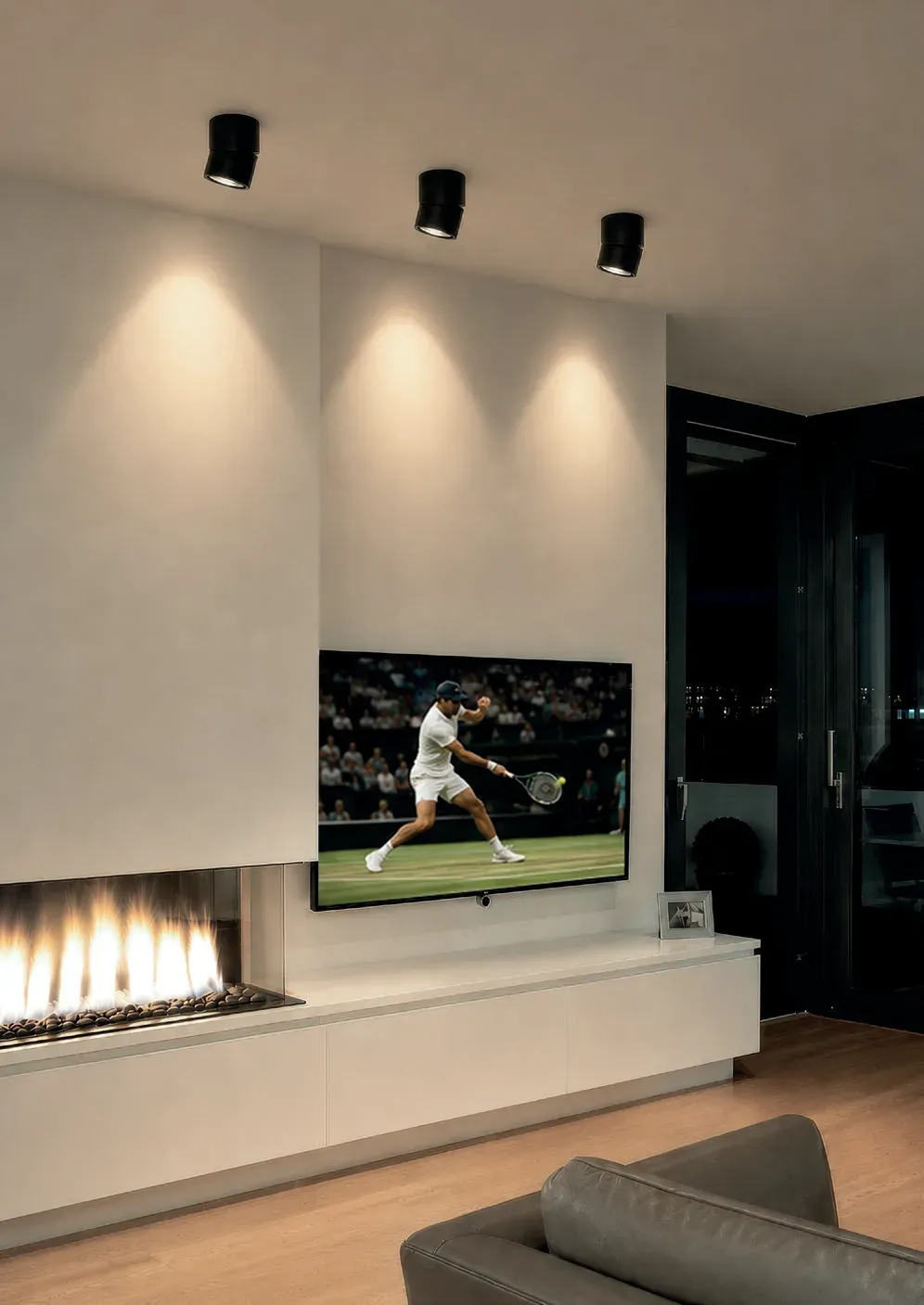 Spot Noxx 1 Aufbauspots in Schwarz über einem Kamin im Wohnraum